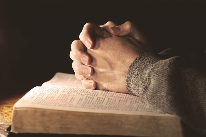 Praying Hands on Bible